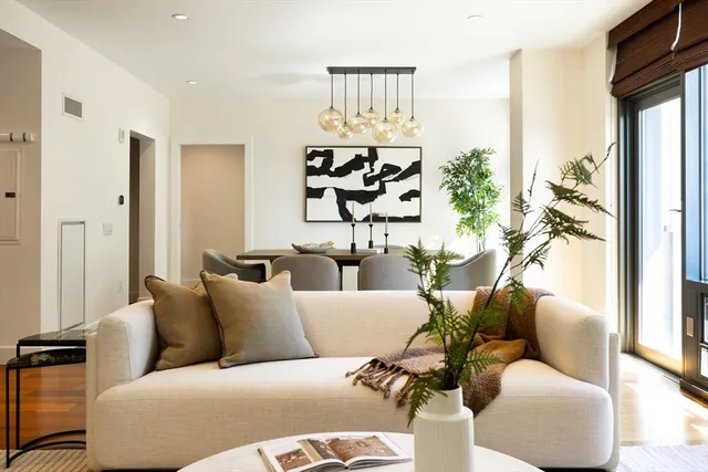 a living room with furniture and large windows