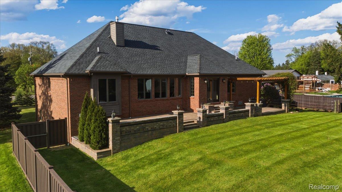 35339 West 13 Mile Road Farmington, MI 48331 - Photo 58 of 72 Back of property featuring a fenced backyard, brick siding, a patio, and a chimney