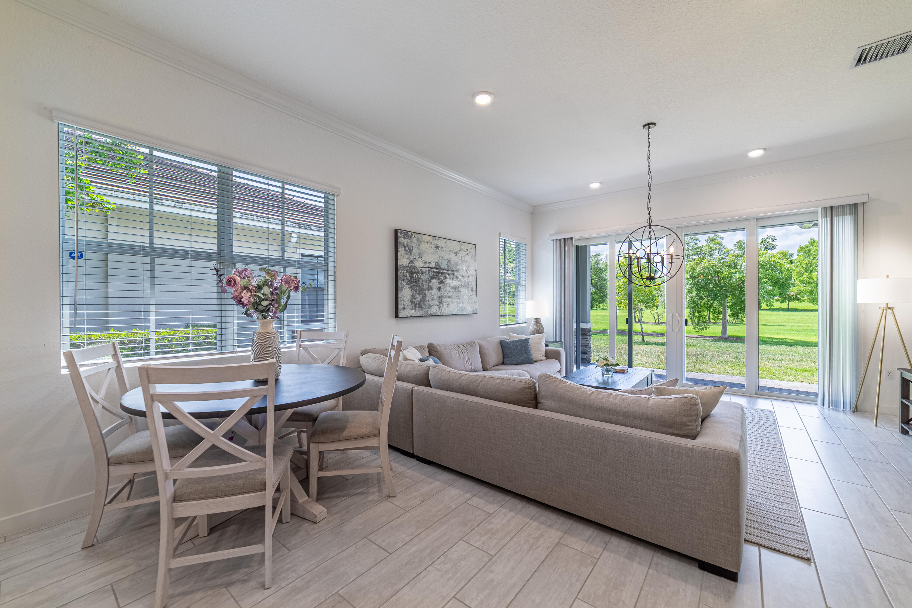 a dining room with furniture and large windows