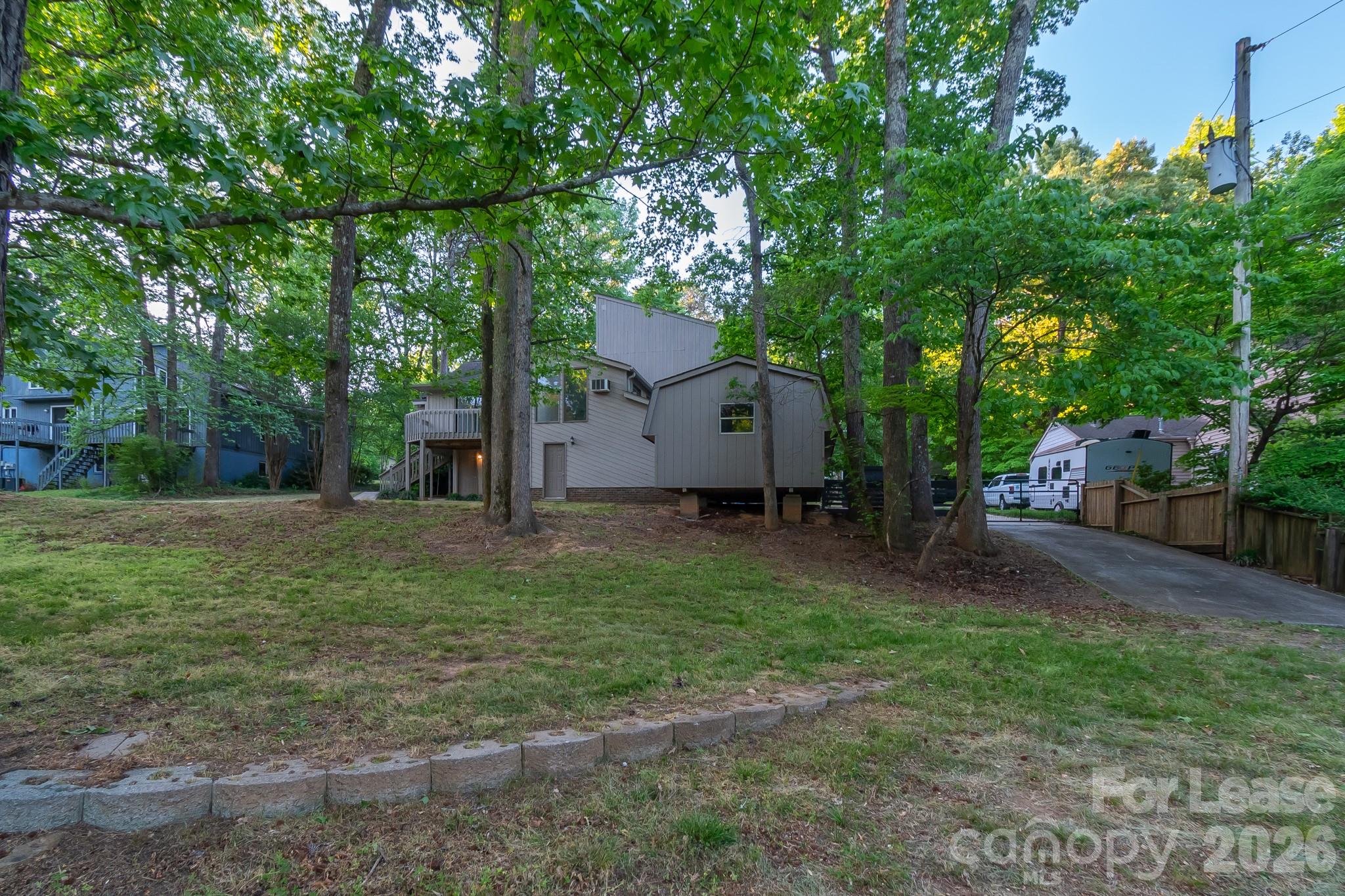 3917 Singletree Road Mint Hill, NC 28227 - Photo 23 of 47 a view of a house with backyard and a tree