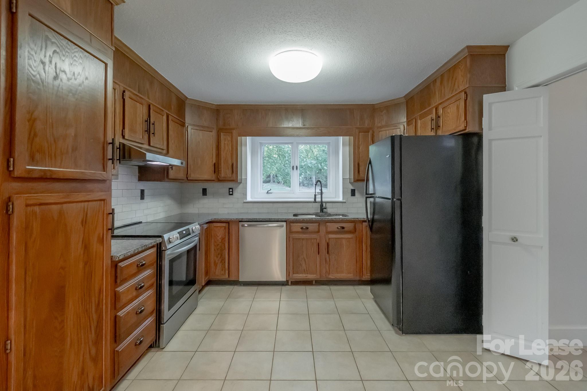3917 Singletree Road Mint Hill, NC 28227 - Photo 25 of 47 a kitchen with stainless steel appliances granite countertop a refrigerator and a sink
