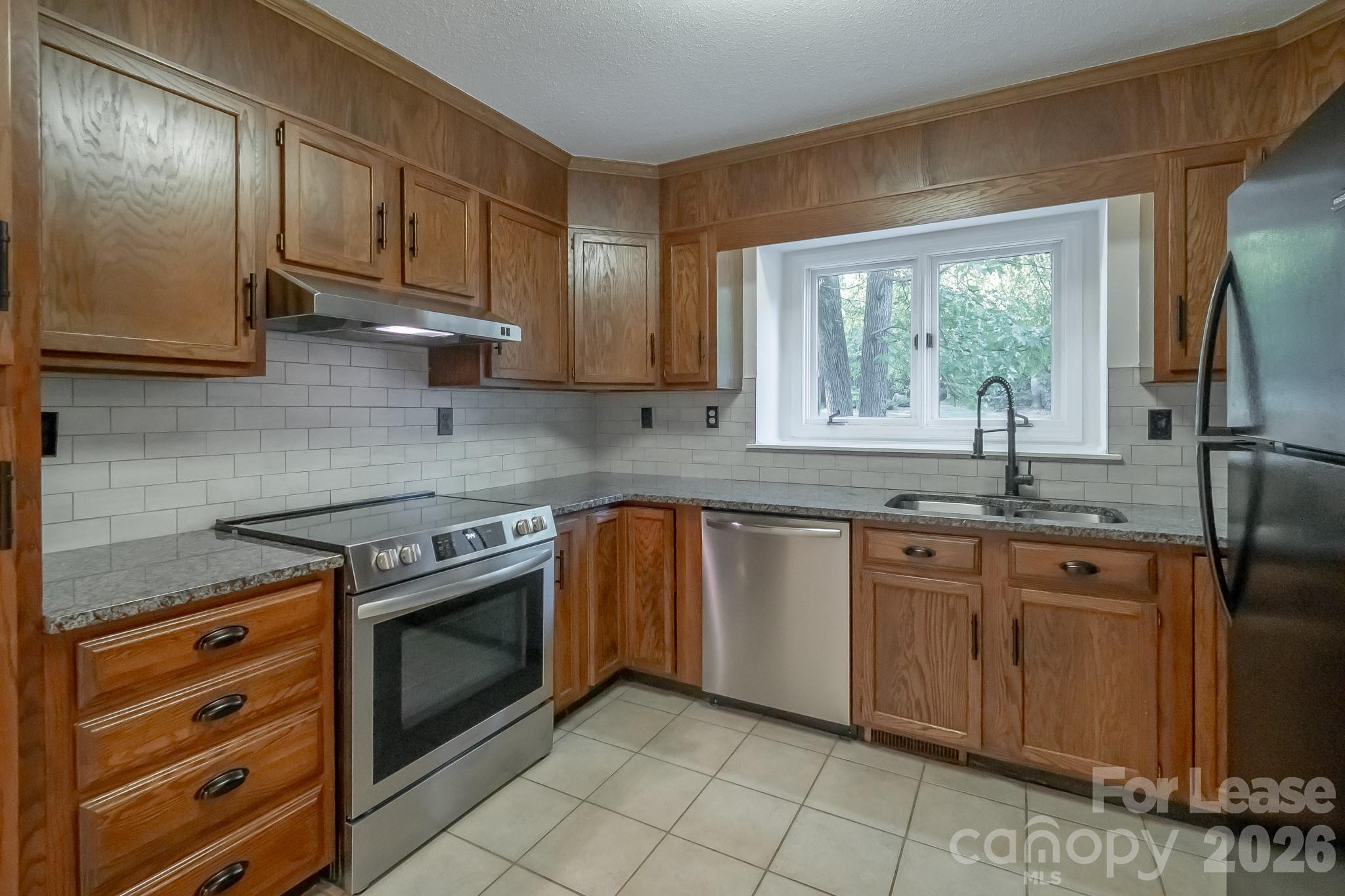 3917 Singletree Road Mint Hill, NC 28227 - Photo 28 of 47 a kitchen with stainless steel appliances granite countertop a sink stove and refrigerator