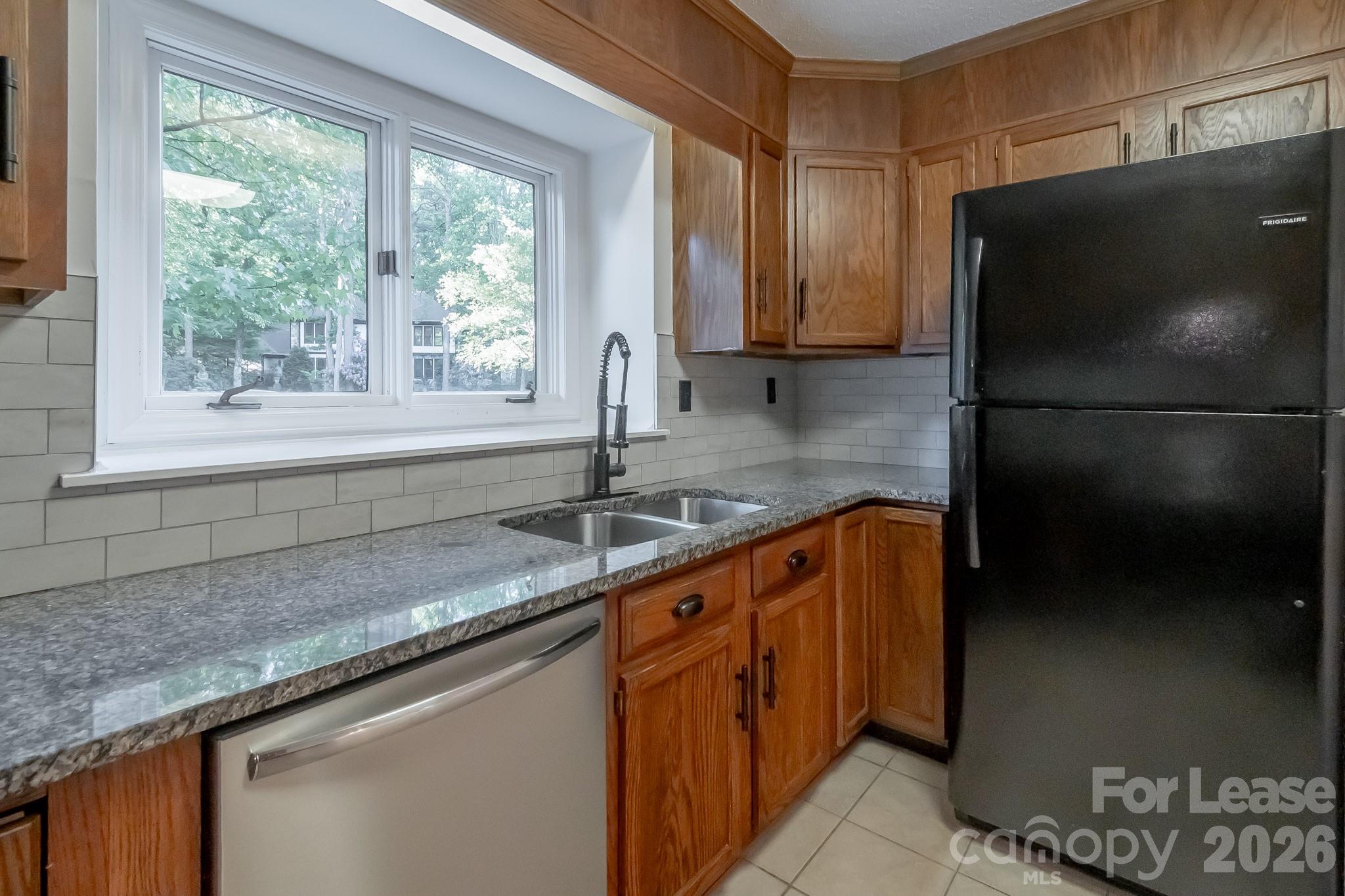 3917 Singletree Road Mint Hill, NC 28227 - Photo 29 of 47 a kitchen with stainless steel appliances granite countertop a sink stove and refrigerator