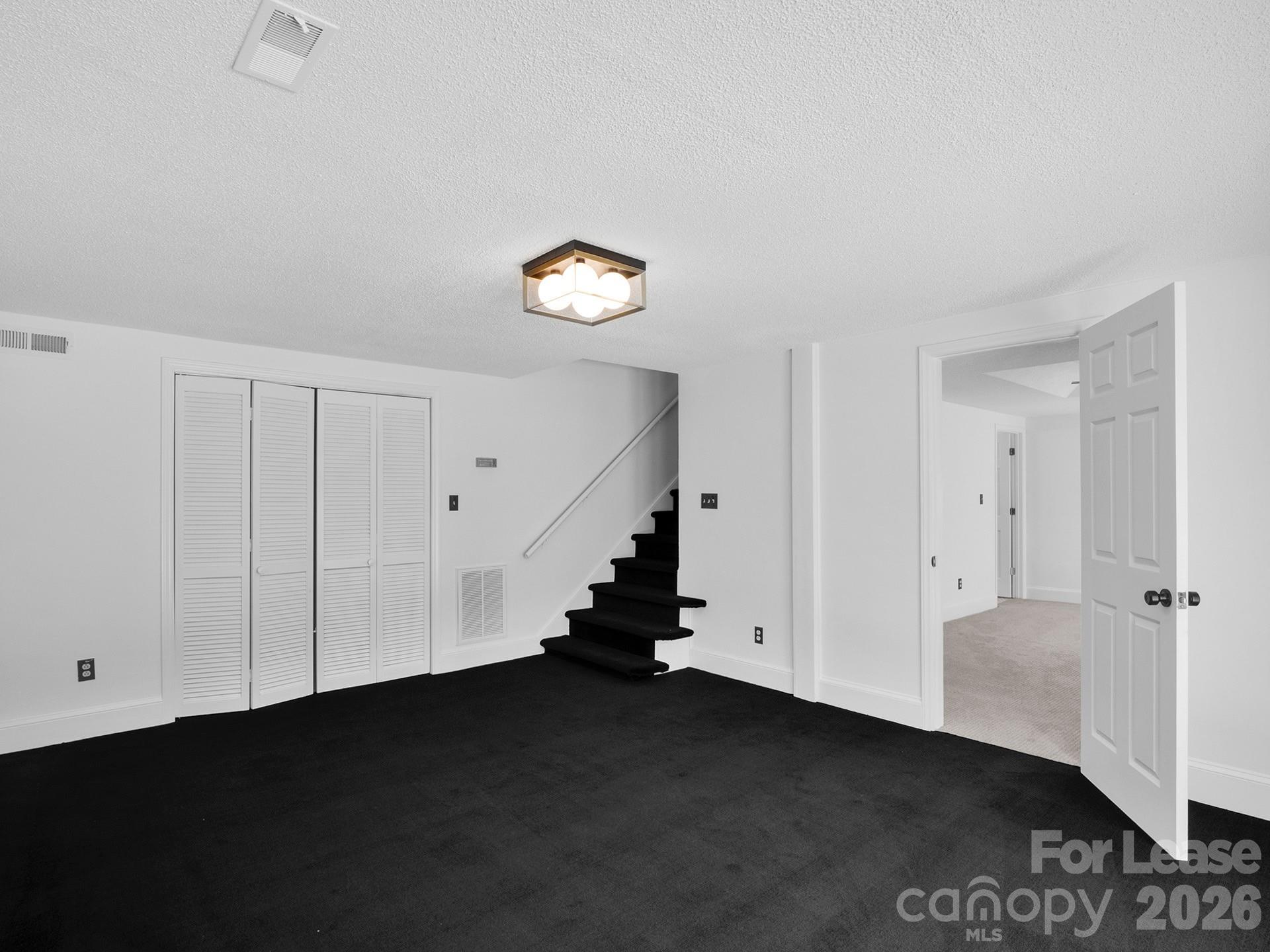 3917 Singletree Road Mint Hill, NC 28227 - Photo 36 of 47 an empty room with a wooden floor and white walls