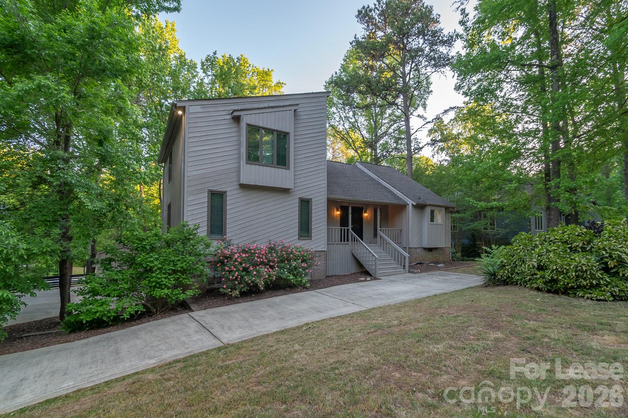 3917 Singletree Road Mint Hill, NC 28227 - Photo 6 of 47 a front view of a house with a yard and potted plants