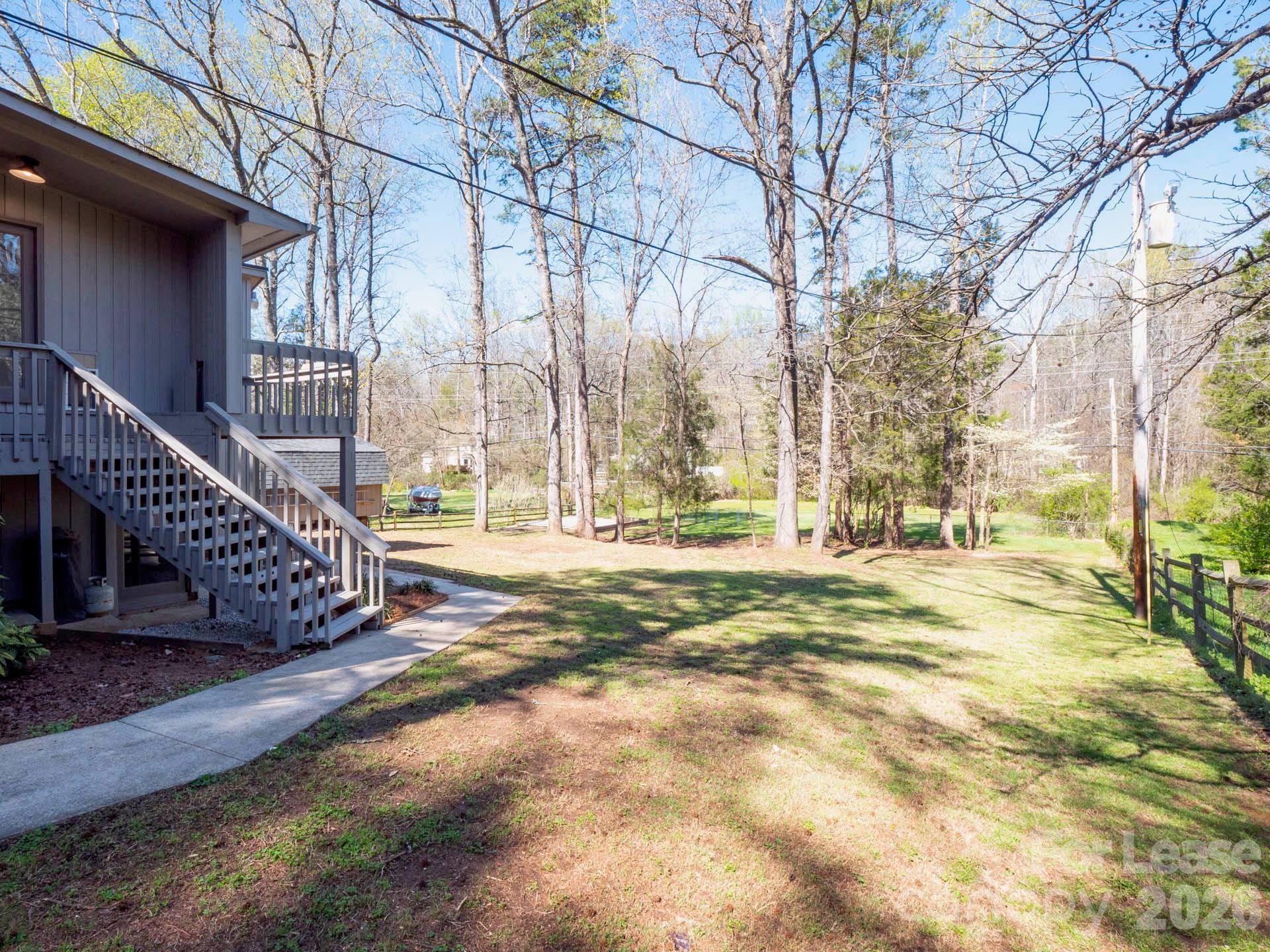 3917 Singletree Road Mint Hill, NC 28227 - Photo 8 of 47 a view of a yard with wooden fence