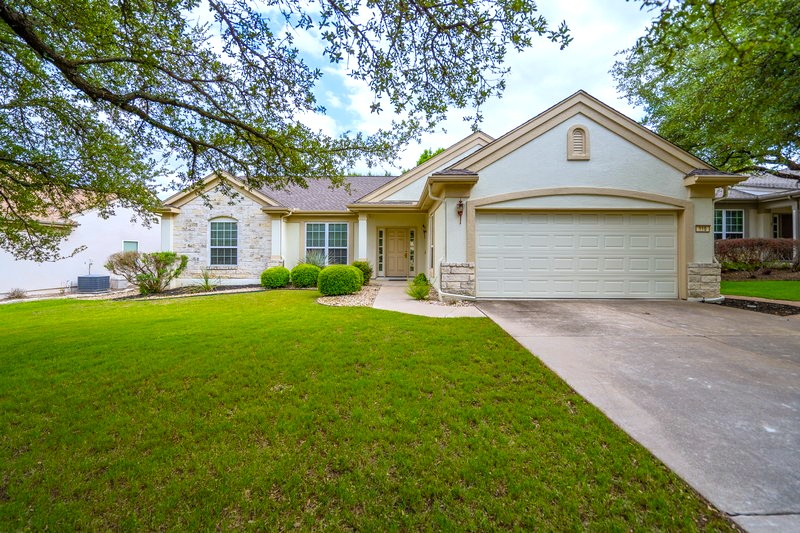 a front view of house with yard and green space