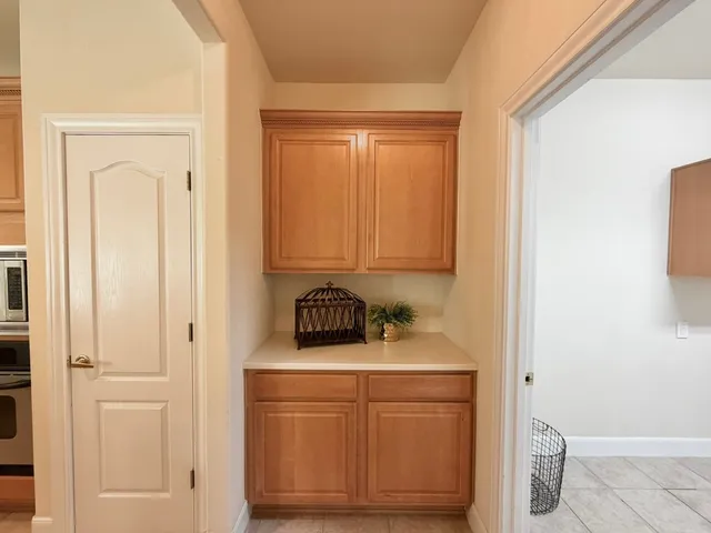 a hallway with a large mirror and a rug