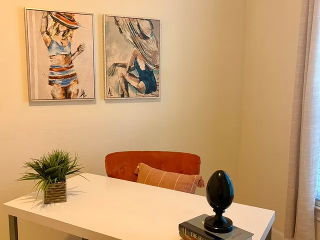 an empty room with windows and chandelier fan