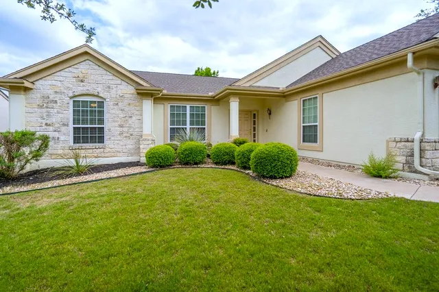 a front view of a house with a yard