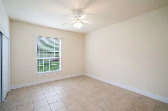 a view of a fountain in front of a house with a big yard
