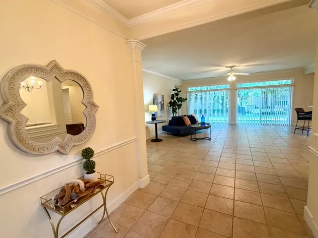 a living room with furniture and a lamp