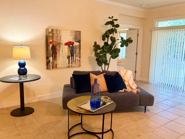 a living room with furniture and a floor to ceiling window