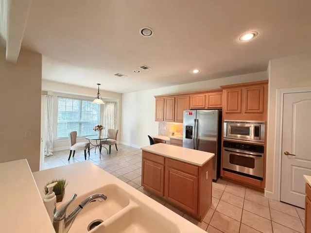 a kitchen with a sink a stove and refrigerator