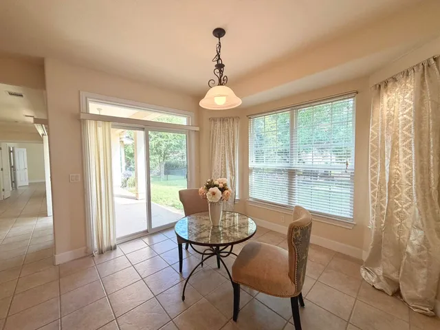 a dining room with furniture and window