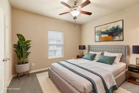 a bedroom with a large bed and a potted plant