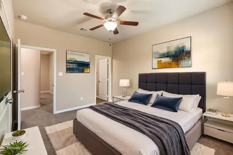 a bedroom with a bed and a chandelier