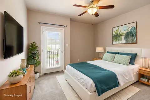 a bedroom with a bed and a flat screen tv