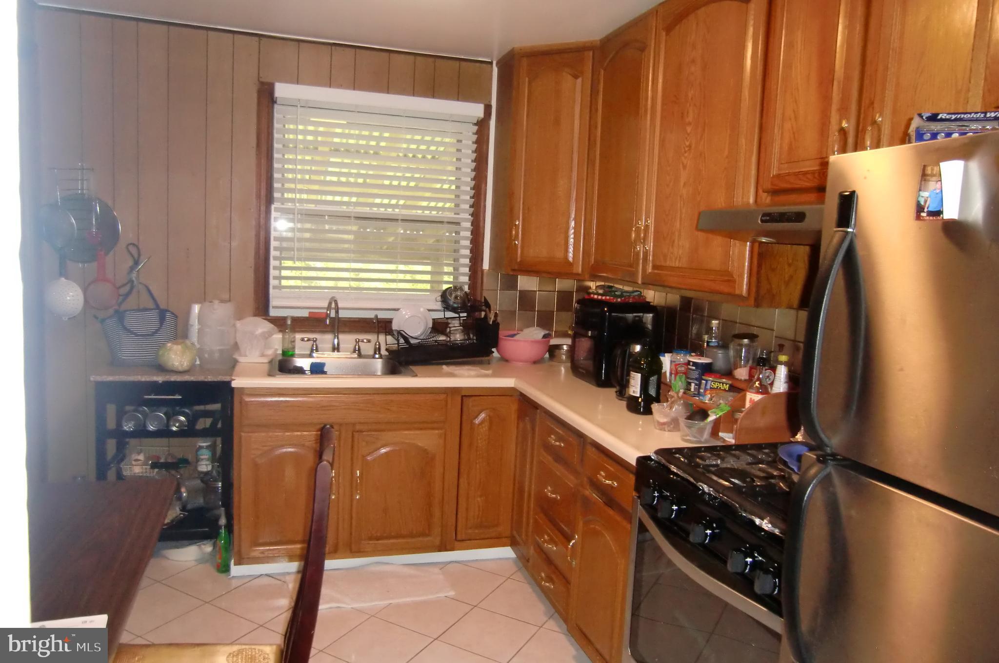 3207 Bryant Avenue Halethorpe, MD 21227 - Photo 7 of 11 a kitchen with a sink and a stove top oven