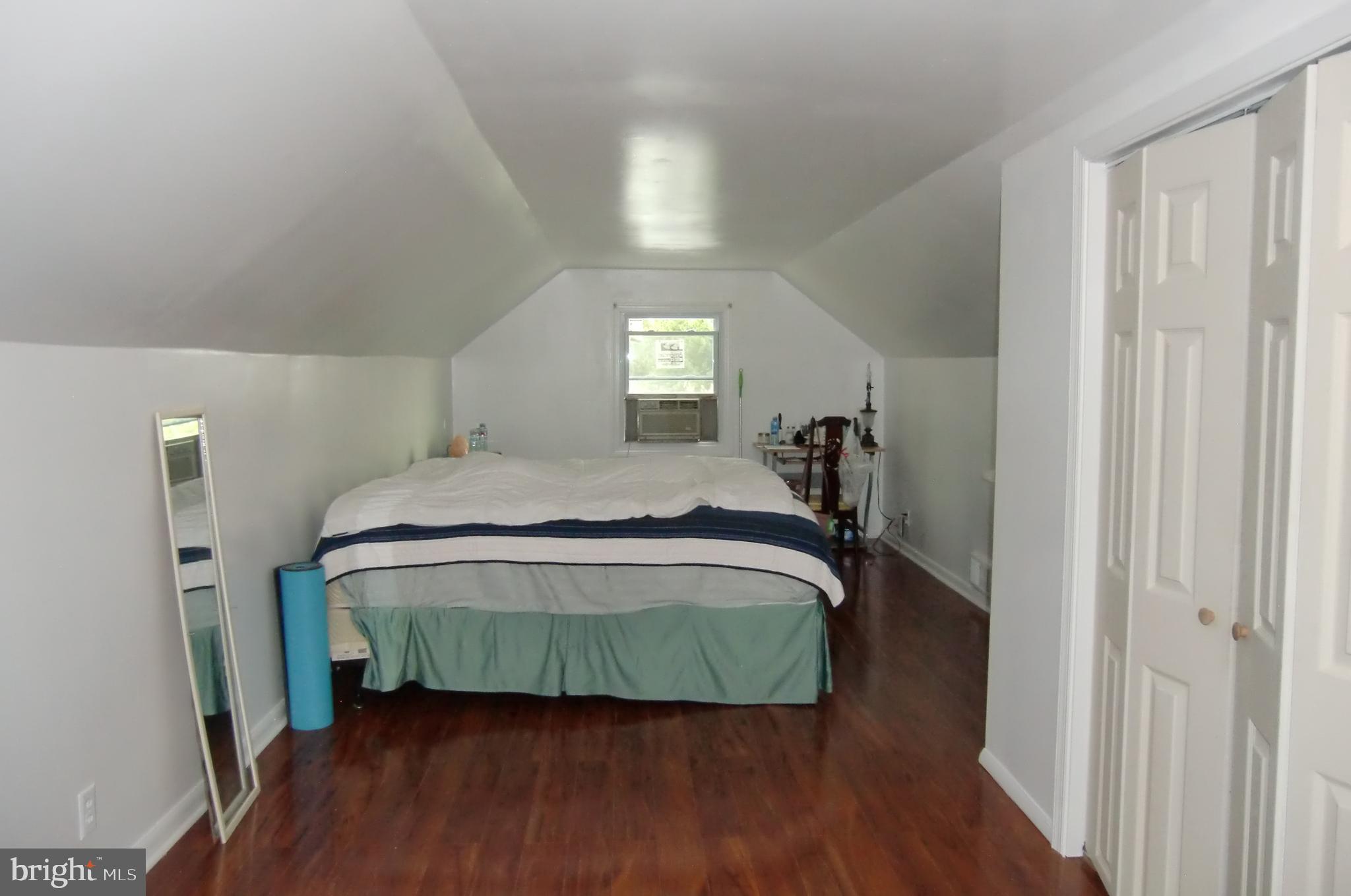3207 Bryant Avenue Halethorpe, MD 21227 - Photo 8 of 11 a bedroom with a bed and wooden floor