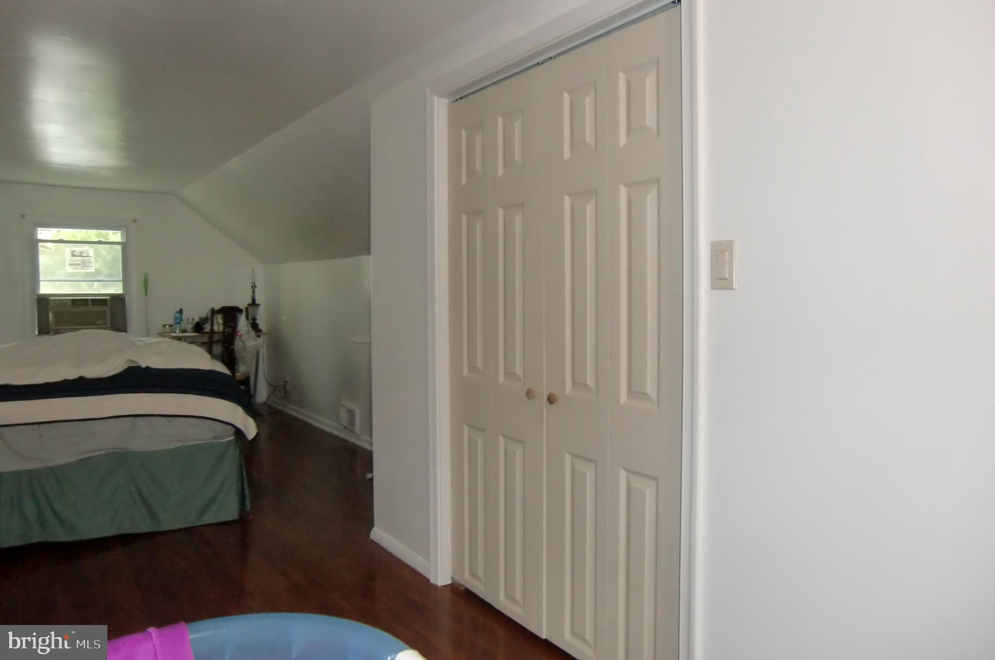 3207 Bryant Avenue Halethorpe, MD 21227 - Photo 9 of 11 a bedroom with a bed and a mirror
