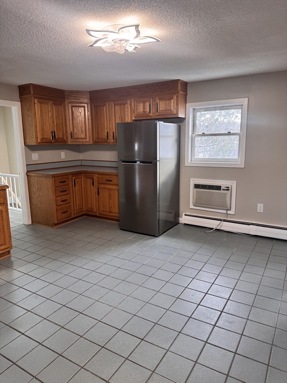66 Taylor Street, Unit 2 Holyoke, MA 01040 - Photo 11 of 29 a kitchen with granite countertop a refrigerator and a stove top oven