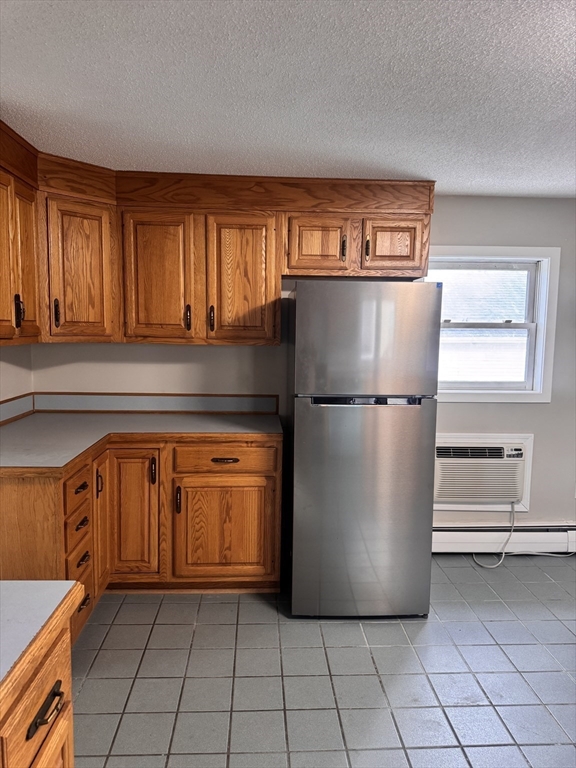 66 Taylor Street, Unit 2 Holyoke, MA 01040 - Photo 12 of 29 a view of kitchen with windows and refrigerator