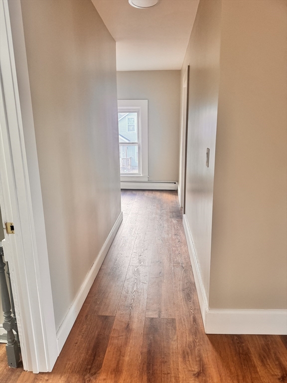 66 Taylor Street, Unit 2 Holyoke, MA 01040 - Photo 17 of 29 a view of a hallway with wooden floor and a bathroom