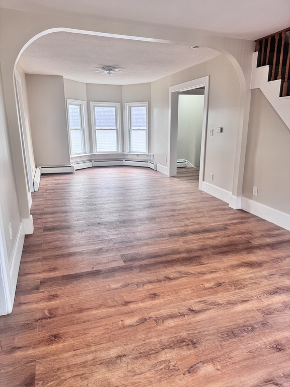 66 Taylor Street, Unit 2 Holyoke, MA 01040 - Photo 3 of 29 a view of room with window and wooden floor