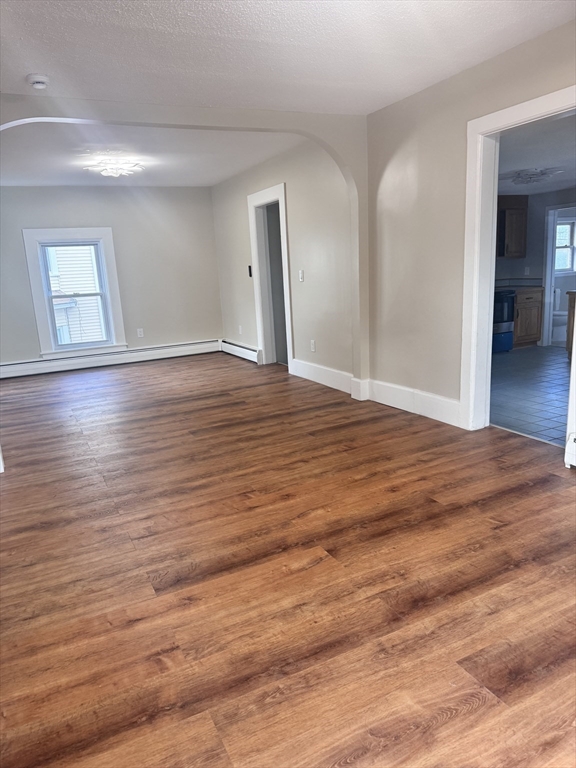 66 Taylor Street, Unit 2 Holyoke, MA 01040 - Photo 6 of 29 a view of empty room with wooden floor