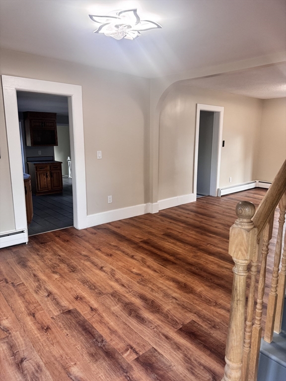 66 Taylor Street, Unit 2 Holyoke, MA 01040 - Photo 7 of 29 a view of a livingroom with wooden floor and closet