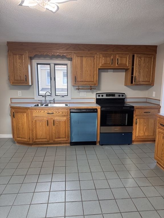 66 Taylor Street, Unit 2 Holyoke, MA 01040 - Photo 8 of 29 a kitchen with stainless steel appliances granite countertop a stove a sink and a microwave