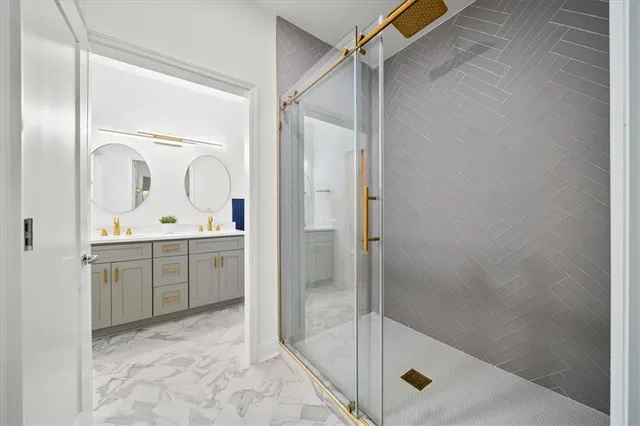 a bathroom with a shower sink and mirror