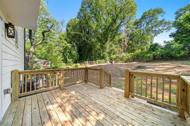 a balcony with wooden floor and outdoor space