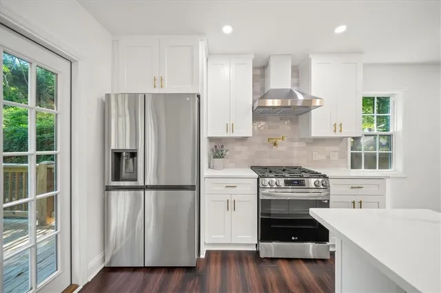 a kitchen with a stove a refrigerator and a sink
