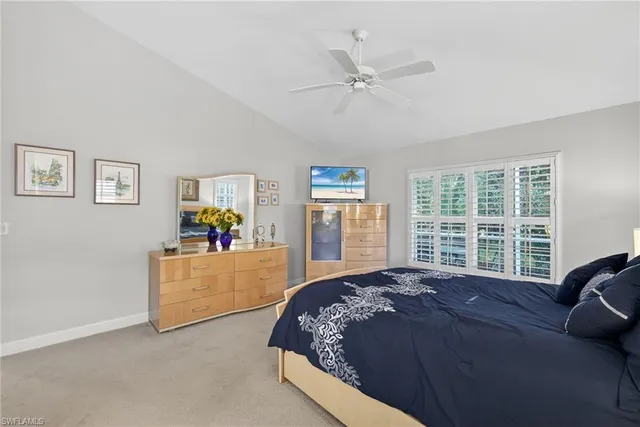 a large bed sitting in a bedroom next to a window with a dresser