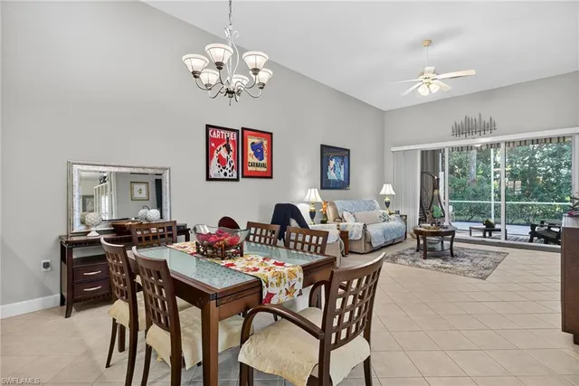 a dining room with furniture a chandelier and window