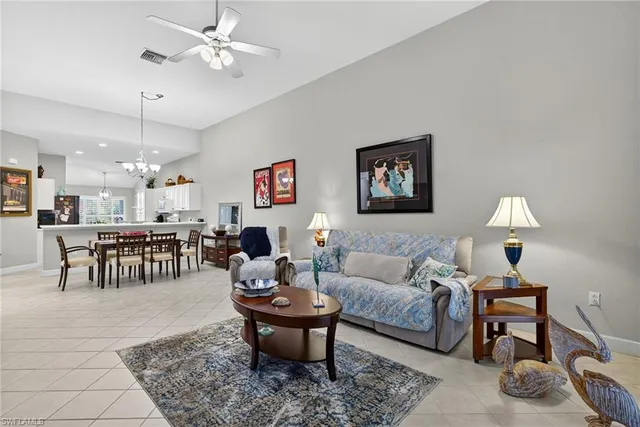 a living room with furniture a table and a chandelier