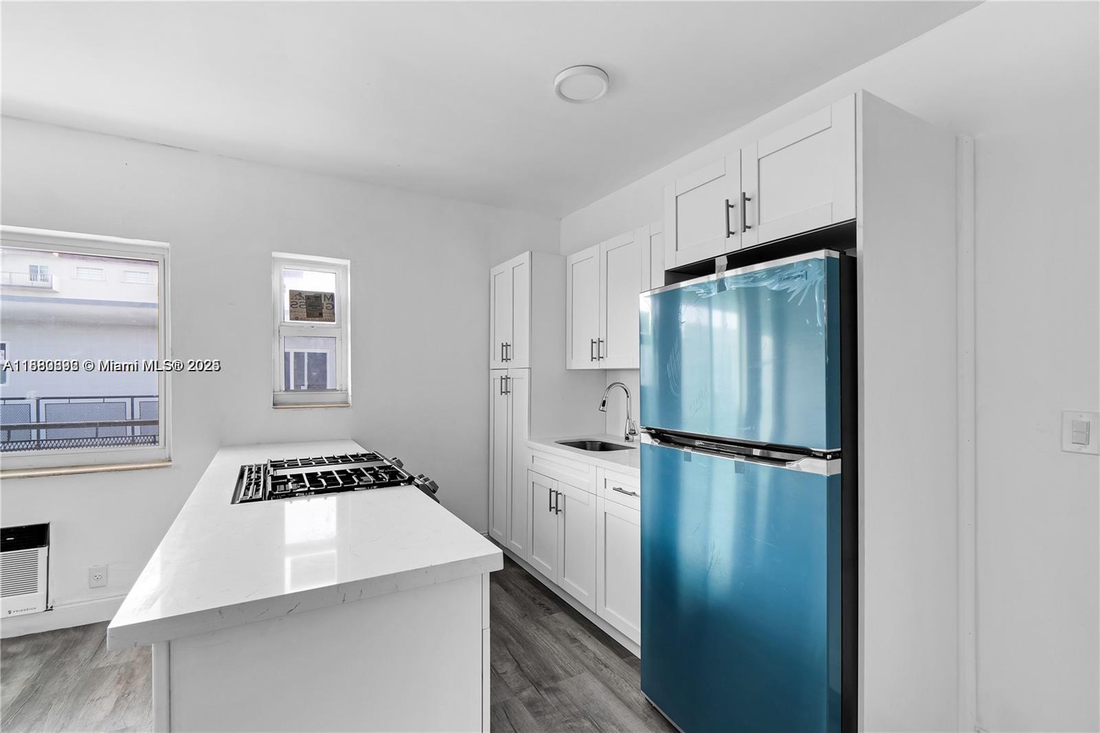 a kitchen with a refrigerator a sink and stove