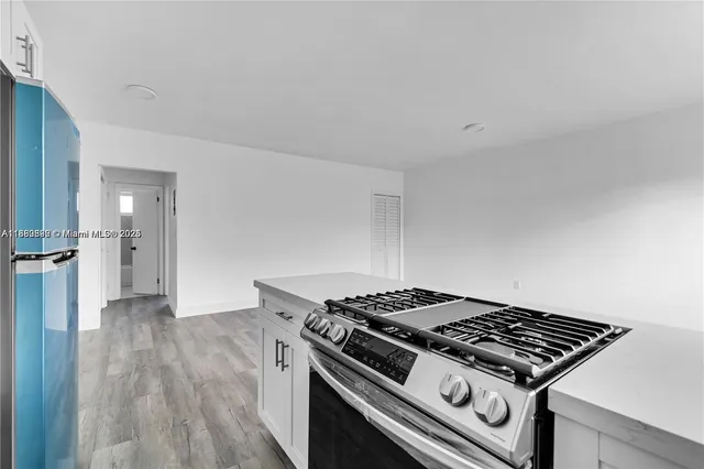 a stove top oven sitting inside of a kitchen