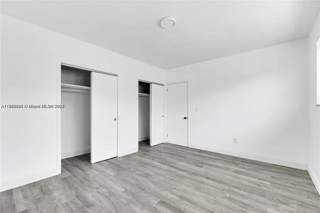 an empty room with wooden floor