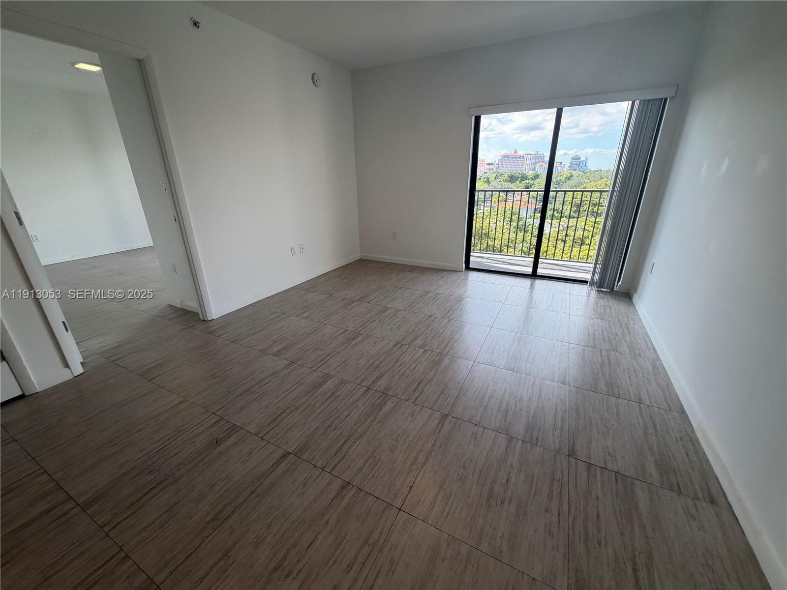 1801 Southwest 32nd Avenue, Unit 504 Miami, FL 33145 - Photo 11 of 14 an empty room with wooden floor and windows