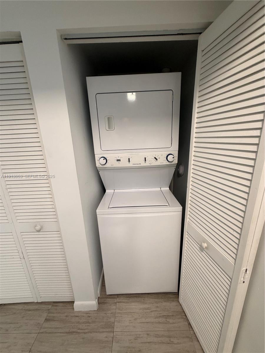 1801 Southwest 32nd Avenue, Unit 504 Miami, FL 33145 - Photo 14 of 14 a utility room with wooden floor washer and dryer