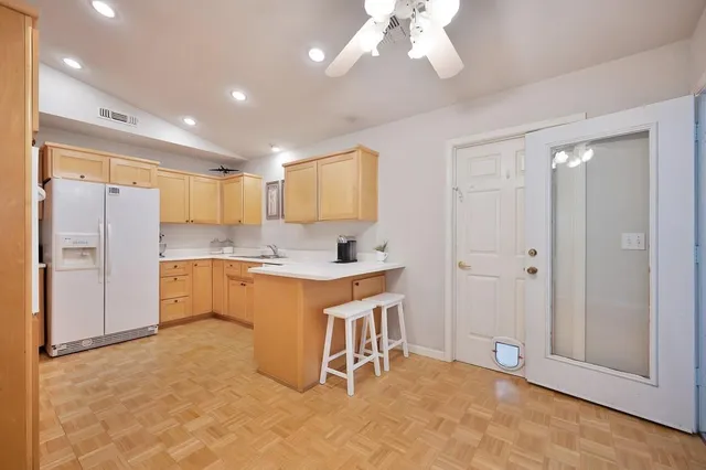 a large kitchen with cabinets and stainless steel appliances