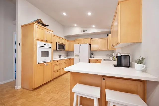 a kitchen with stainless steel appliances granite countertop a refrigerator sink and cabinets