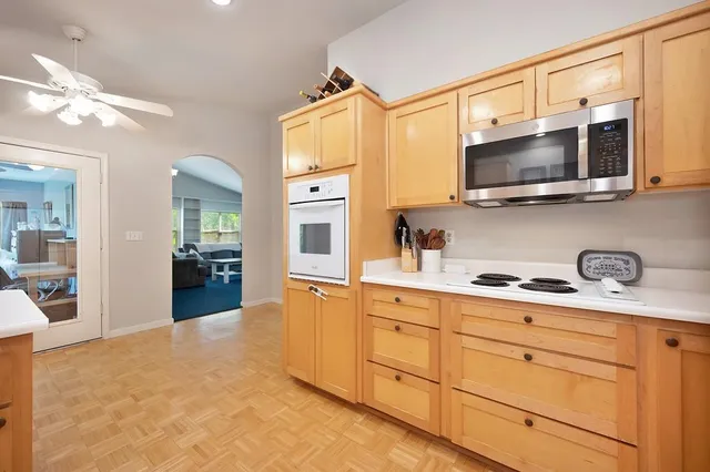 a kitchen with stainless steel appliances granite countertop a sink and a microwave
