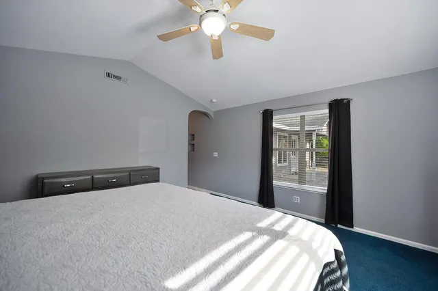 a bathroom with a tub a sink and mirror