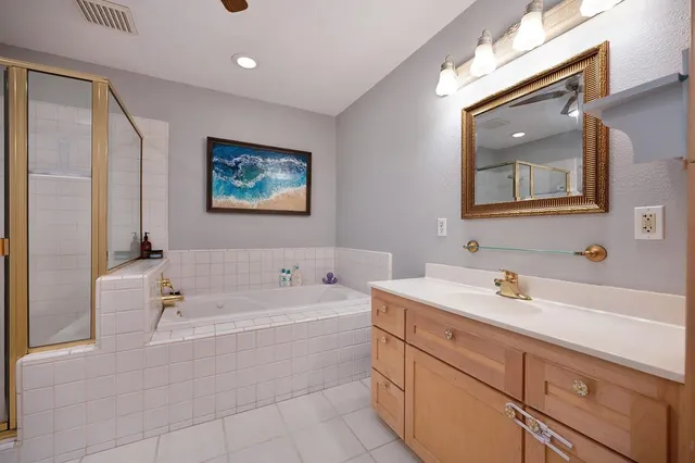 a spacious bathroom with a tub and a shower