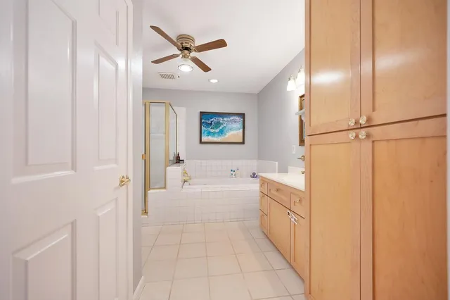 a bathroom with a sink a toilet a mirror and shower