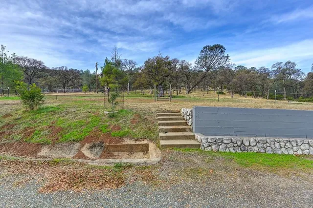 a view of a swimming pool with a yard